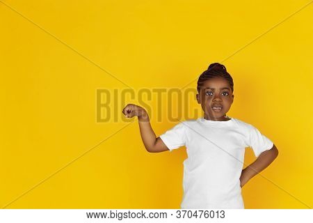 Greeting Somebody, Showing Brofist. Little African-american Girls Portrait On Yellow Studio Backgrou