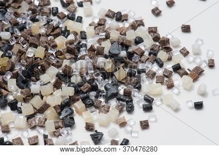 Brown, Grey And Transparent Polymer Resin And Regrind On White In Lab