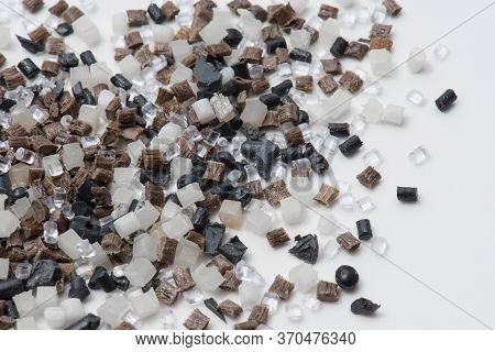 Brown, Grey And Transparent Polymer Resin And Regrind On White In Lab