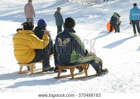 ZAGREB, CROATIA - JANUARY 12, 2014: Children sledging and having fun in snow, Park Maksimir in Zagreb, Croatia