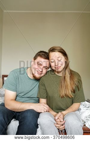 Tired Beautiful Married Couple In Casual Clothes Sitting At Home Together During Lockdawn