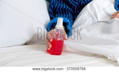 Closeup Photo Of Young Sick Woman Holding Thoat Spray In Hand