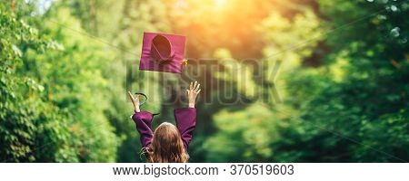 Photo From Back Graduate Graduated Little Girl In Cap Throw It Up In The Sky, Happy Of Ending, Viole