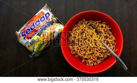 Cyberjaya, Malaysia - June 6, 2020: Top View Of Fried Instant Noodle Or Maggie With Fork In A Red Bo