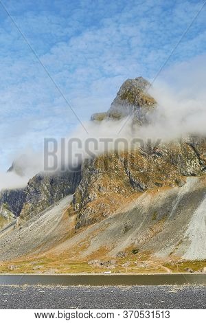 Exploring Nature In Iceland. Close Up Shot Of Impressive Eystrahorn Mountain With Fog Rings Around A