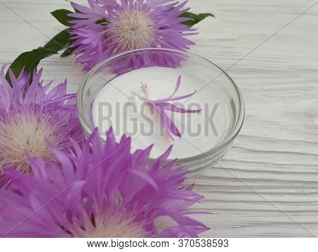 Cream Cosmetic Flower On A Wooden Background