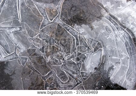 Frozen Puddle With Broken Ice. Winter Season.