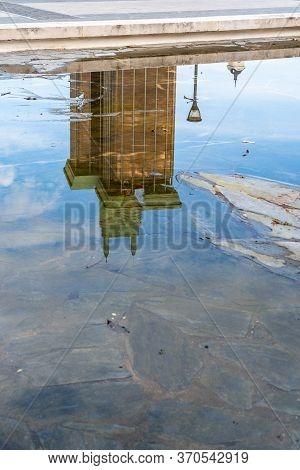 Madrid, Spain - June 7, 2020: Reflection Of The Towers Of Colon On Pond Of Gardens Of Discovery