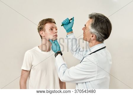 Ophthalmology Clinic. Professional Mature Male Ophthalmologist In Medical Uniform Examining Eyes Of 