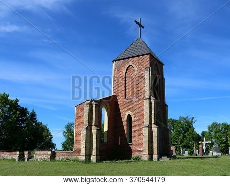 Remains Of Foundation Bell Tower And Front Wall Of Old Church With Cemetery And Crucifix In Backgrou