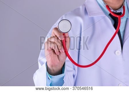 Medical Doctor Or Physician In White Gown Uniform With Stethoscope In Hospital Over White Wall Backg