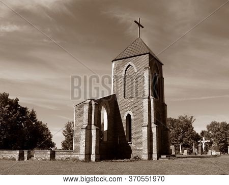 Remains Of Foundation Bell Tower And Front Wall Of Old Church With Cemetery And Crucifix In Backgrou