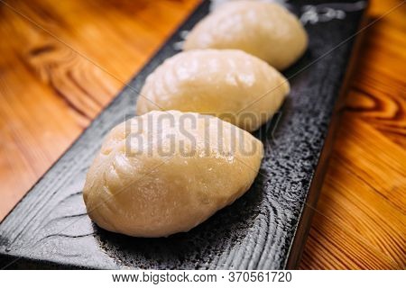 Closeup On Korean Steamed Pjan-se Pigodi Pies With Cabbage And Meat , Horizontal