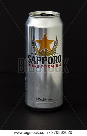 Calgary, Alberta, Canada. June 08, 2020. An Isolated Stella Sapporo Tallboy Beer Can On A Black Back