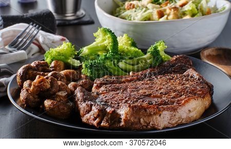 seared ribeye steak with broccoli and sauteed mushrooms