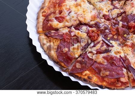 Slices Of Pizza With Salami And Cheese On A Paper Plate. Black Wooden Table. Copy Space. Empty Place