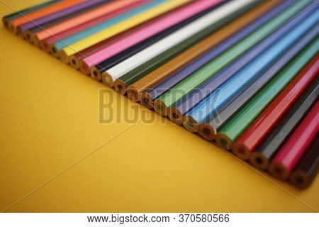 Colored Pencils Set Presented In A Diagonal Line With A Yellow Background