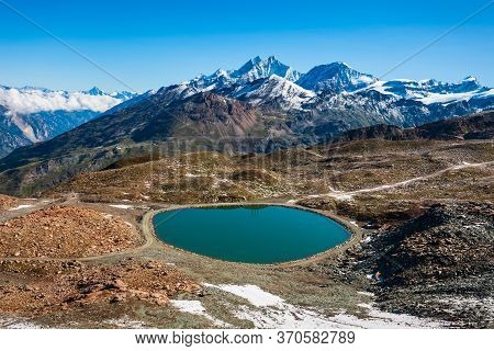 Riffelsee Lake And Matterhorn Mountain In The Alps, Located Between Switzerland And Italy