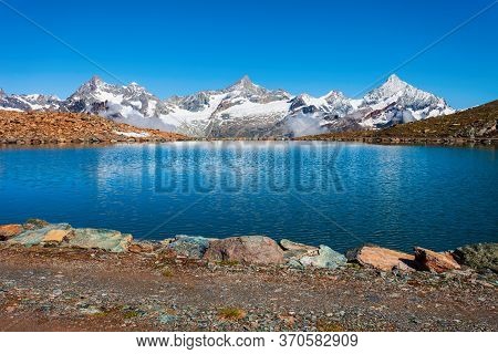 Riffelsee Lake And Matterhorn Mountain In The Alps, Located Between Switzerland And Italy