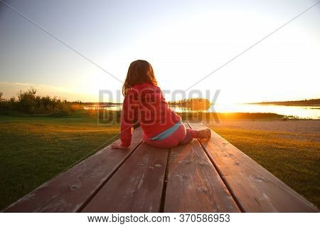 Elk Island National Park, Alberta Canada, June 07, 2020: A Child At Play Pauses To Enjoy The Sunset 