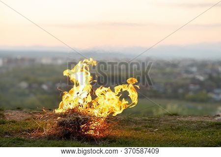 Big Bright Bonfire Bugning At Field In Evening.