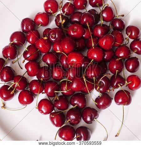 Top View Of A Lot Of Fresh Sweet Cherry Fruit Berries With Water Drops. Close-up On The White Backgr