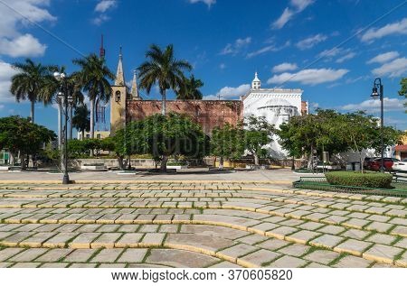 Santa Ana Park And Church With Tropical Trees With Sunny Blue Sky, Merida, Yucatan, Mexico