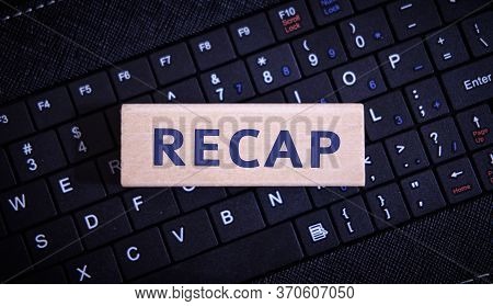Recap - Text On A Wooden Object On A Black Keyboard