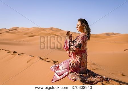 Girl In Moroccan Dress In Sahara Desert.