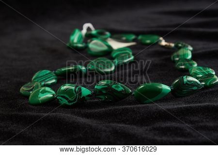 Beads From Zoisite Semiprecious Stone On Black Velor. Close Up
