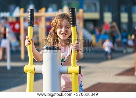 Cute Little Girl Sports On The Playground