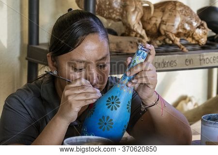 Sant Matin Ticajete, Mexico - 2019-11-26 - Woman Paints Fine Details On Alebrije Wooden Sculpture.