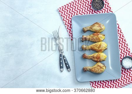 Grilled Chicken Legs On Plate On Grey Background. Top View.