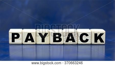 Concept Word Payback On Cubes On A Blue Background. Business Concept.