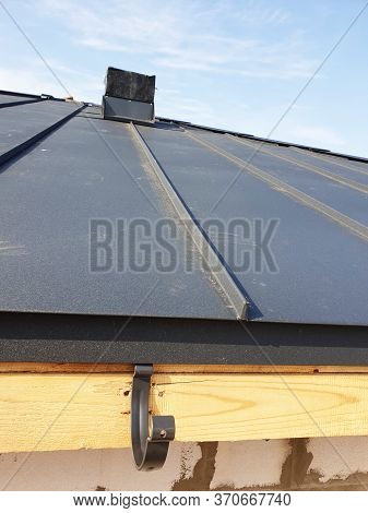 Close Up View Of Folded Roof Of House Under Construction With Holders For Gutters Water Drainage Sys