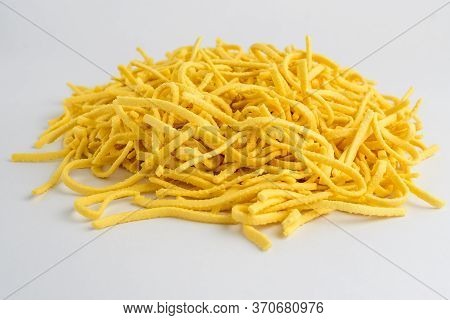 Dried Spätzle German Type Of Home Made Pasta In A Round Display Ready To Be Cooked, Isolated On Whit
