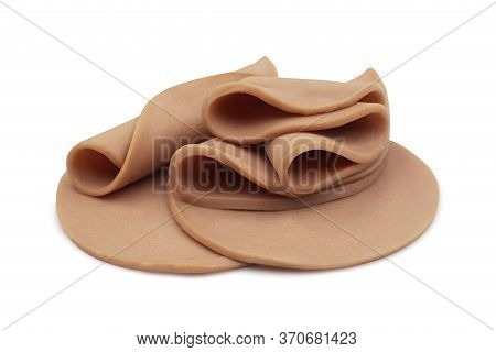 Sliced Of Bologna Sausage Rolled And Heap On White Isolated Background With Clipping Path. Bologna S