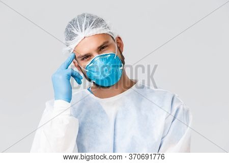 Covid-19 Pandemic, Virus Outbreak, Clinic And Healthcare Workers Concept. Young Thougtful Doctor In 
