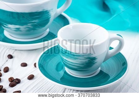 White Cups On A White Background With Coffee Beans