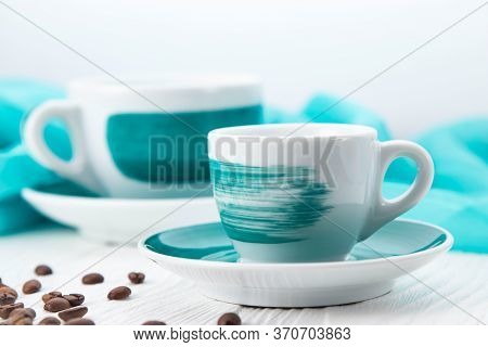 White Cups On A White Background With Coffee Beans