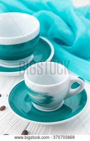 White Cups On A White Background With Coffee Beans