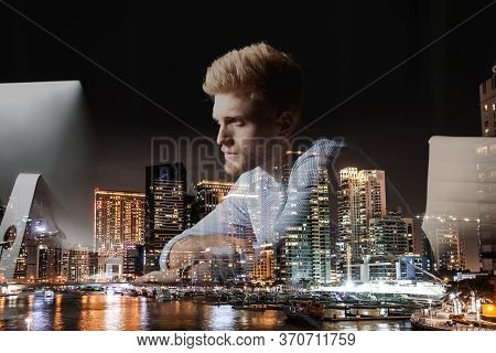 Double Exposure Of Young Man Working In Office And Night Cityscape. Financial Analytics