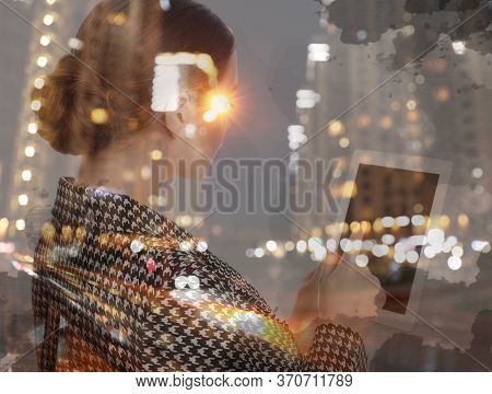 Double Exposure Of Young Woman Using Tablet And Night Cityscape. Financial Analytics