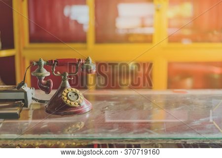 A Red Telehones With Rotary Dial With Dust And Scratches And Credit Card Machine In Ancient Times Pl