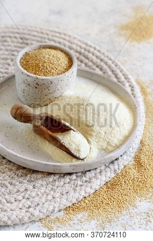 A Plate Of Raw Amaranth Flour With A Scoop And A Bowl Amaranth Seeds Close Up
