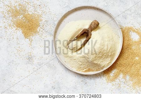 Bowl Of Raw Amaranth Flour With A Spoon Of Amaranth Seeds Top View