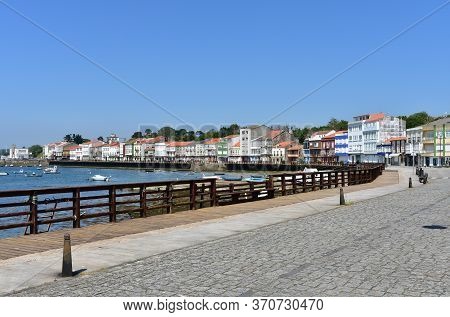 Fishing Village With Wooden Boardwalk, Colorful Houses And Boats With Blue Sky. Mugardos, Galicia, S