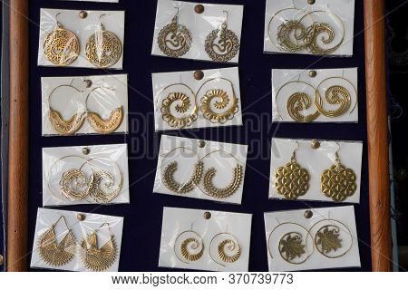 Indian Earrings Kept In Small Plastic Pouches For Sale In The Local Market. Variety Of Earrings Made