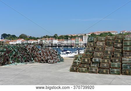 Fishing Village And Harbour With Colorful Houses And Boats With Blue Sky. Mugardos, Galicia, Spain.