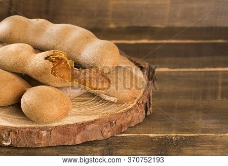 Tamarind Tropical Fruit - Tamarindus Indica. Wood Background